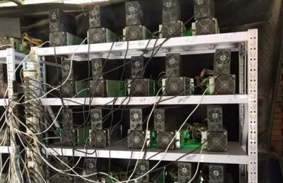 Expert technicians repairing a state-of-the-art mining rig for optimal Bitcoin performance